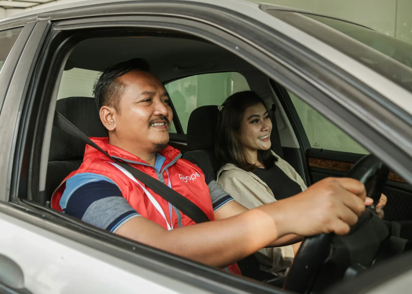 An instructor teaching a student in a car
